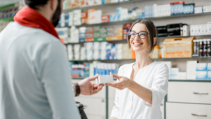 Pharmacists gives serialised medicine to a customer